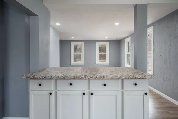 a kitchen with white cabinets and white appliances