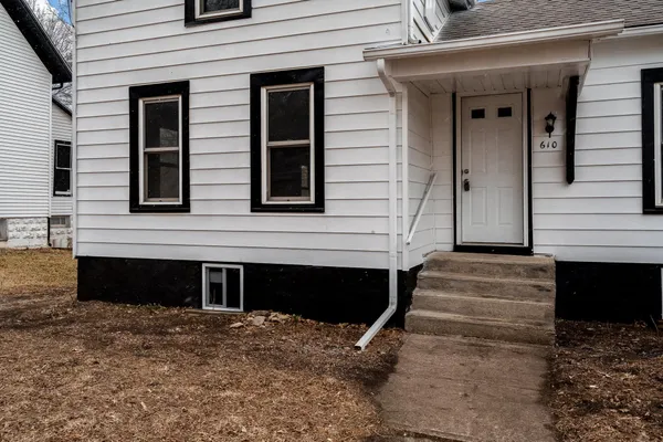 a front view of a house with a parking space