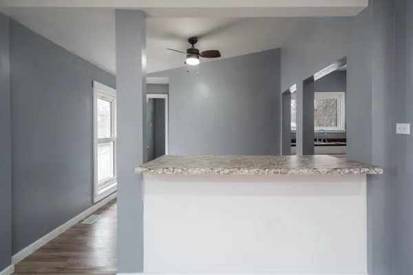 a kitchen with granite countertop white cabinets and white appliances