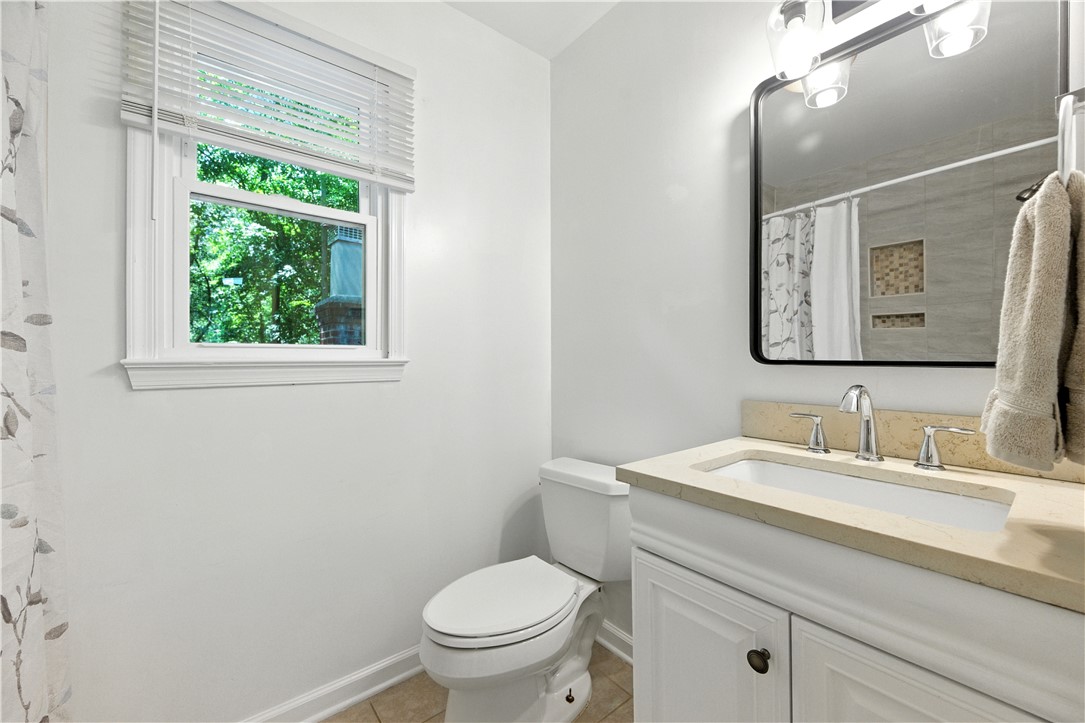 111 Braddock Road Williamsburg, VA 23185 - Photo 26 of 43 Bathroom with vanity, curtained shower, and light tile patterned floors