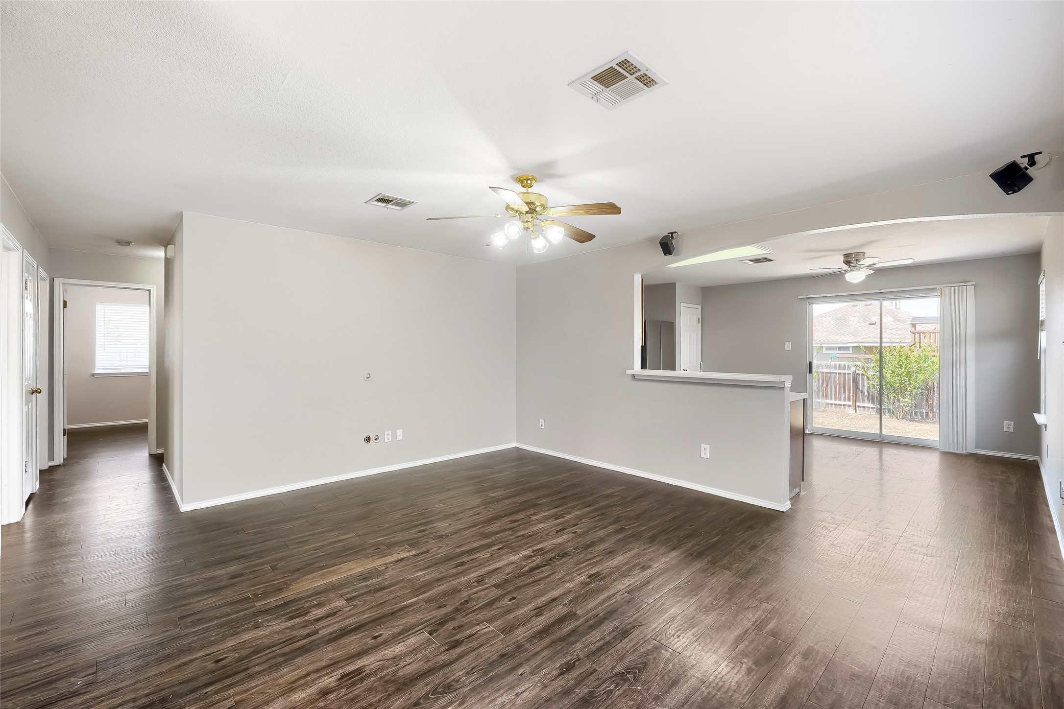113 Mason Reed Cove Kyle, TX 78640 - Photo 8 of 27 Living room looking towards the kitchen and the backyard