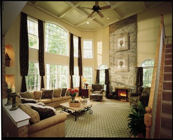 a living room with furniture and large windows