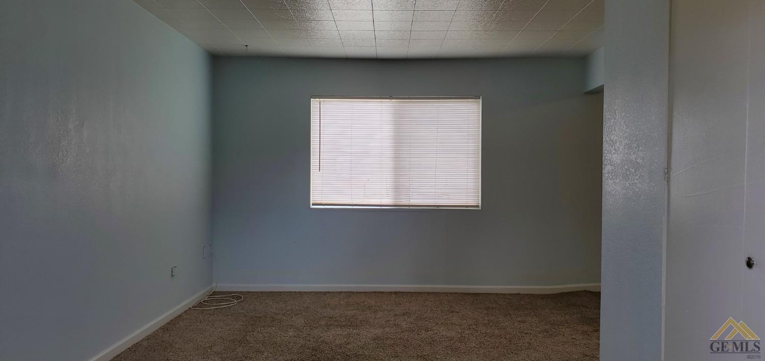 Undisclosed Address Wasco, CA 93280 - Photo 11 of 12 a view of an empty room with a window