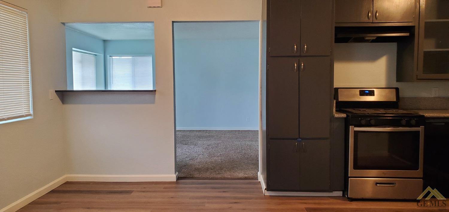 Undisclosed Address Wasco, CA 93280 - Photo 4 of 12 a kitchen with a refrigerator and a stove