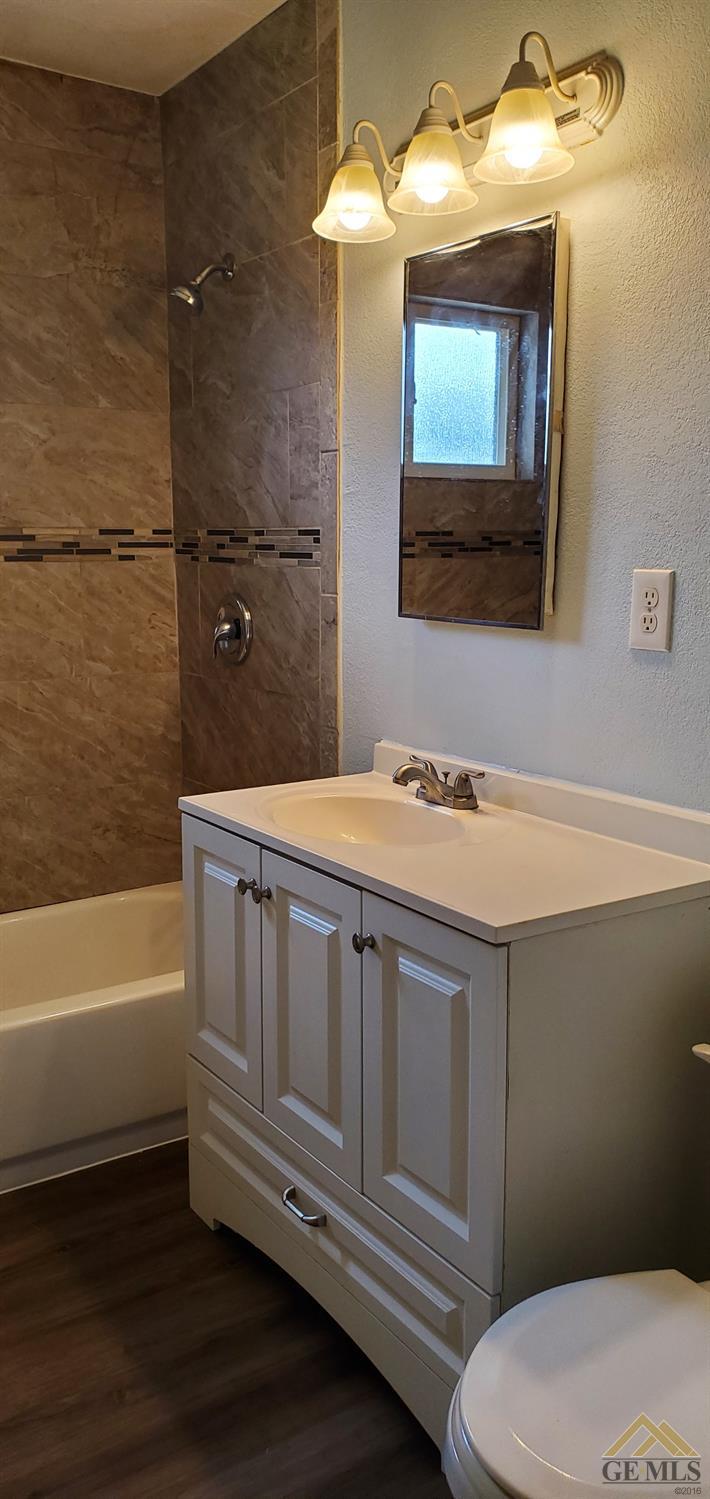 Undisclosed Address Wasco, CA 93280 - Photo 6 of 12 a bathroom with a sink a toilet and bathtub