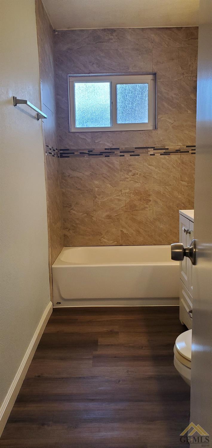 Undisclosed Address Wasco, CA 93280 - Photo 7 of 12 a bathroom with a toilet and a bathtub