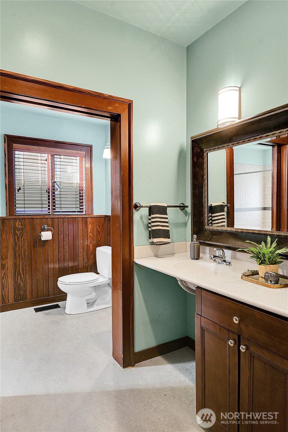 916 20th Avenue East Seattle, WA 98112 - Photo 15 of 28 a bathroom with a double vanity sink toilet and mirror