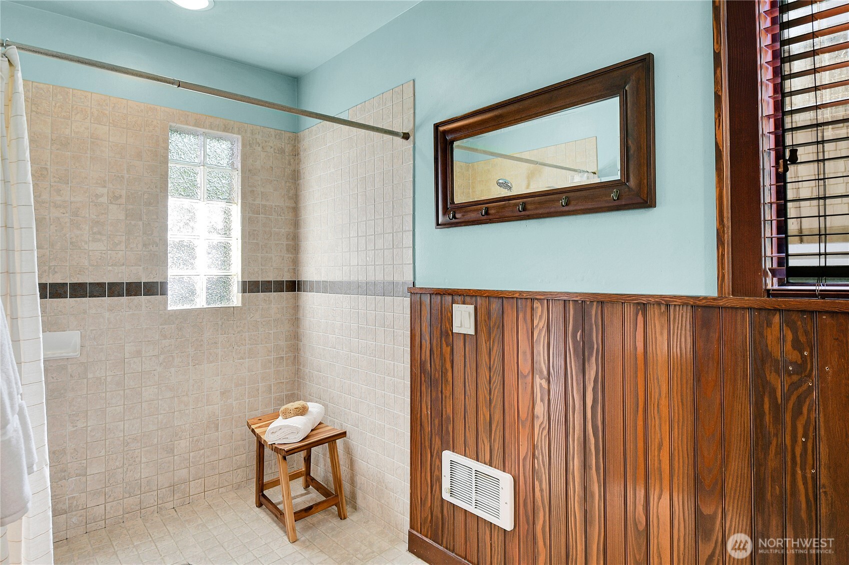 916 20th Avenue East Seattle, WA 98112 - Photo 16 of 28 a view of a room with a window and a painting on the wall