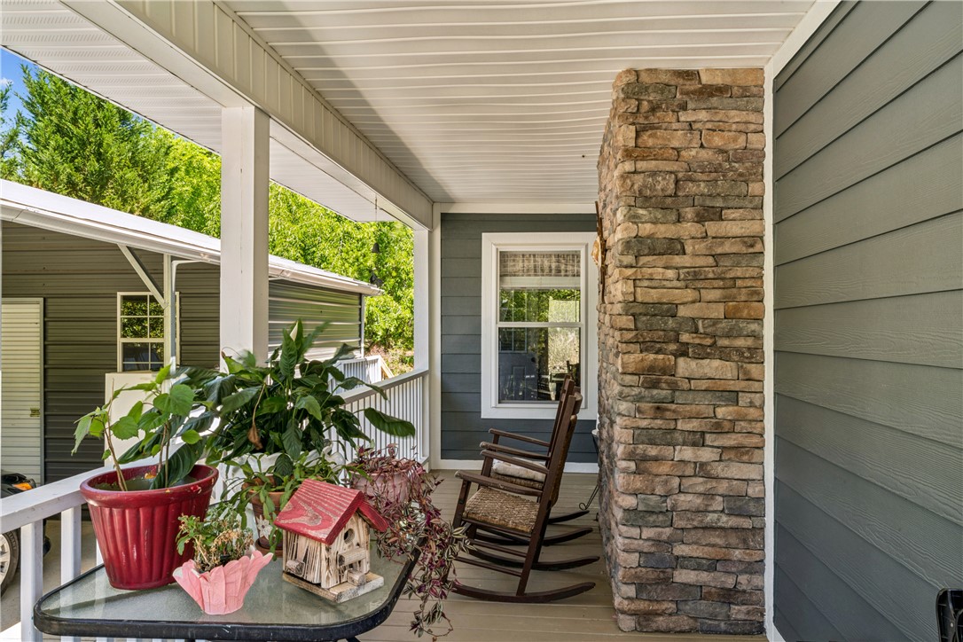 189 Little Choestoea Road Westminster, SC 29693 - Photo 35 of 38 This inviting porch, complete with a stone column, offers a serene outdoor retreat.