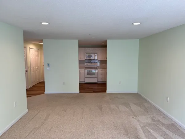 a view of an empty room with closet and cabinet