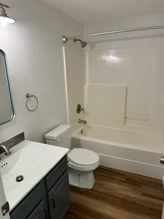 a bathroom with a sink mirror vanity and toilet
