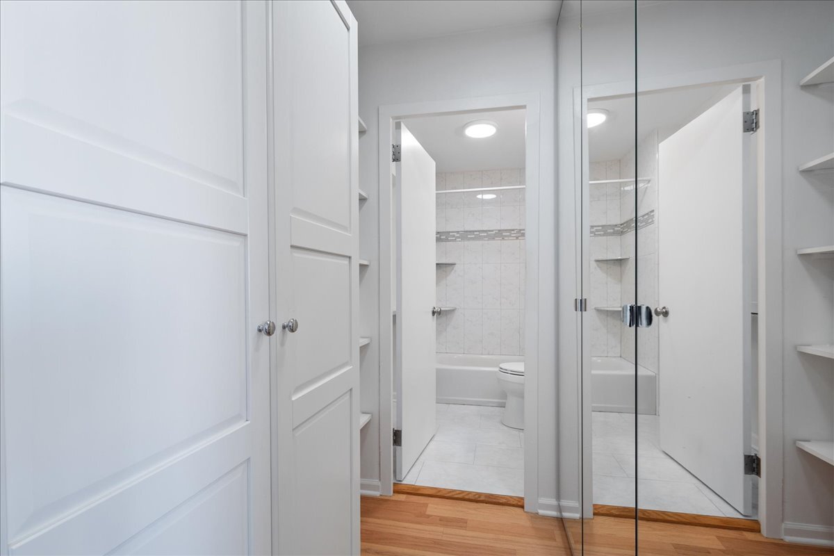 5701 North Sheridan Road, Unit 29N Chicago, IL 60660 - Photo 12 of 19 a bathroom with a shower and a glass door