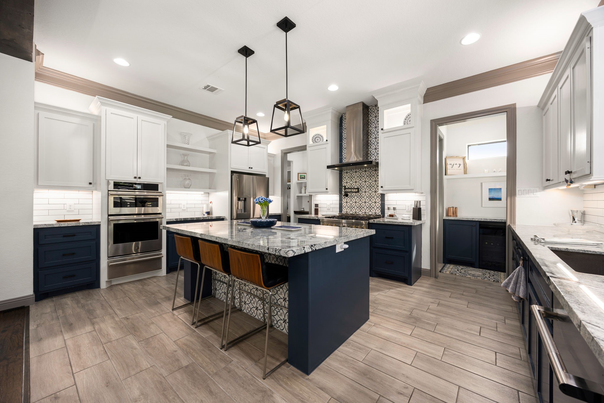 86 Dawns Edge Conroe, TX 77356 - Photo 12 of 50 a kitchen with stainless steel appliances granite countertop a stove a sink dishwasher a refrigerator and a dining table with wooden floor
