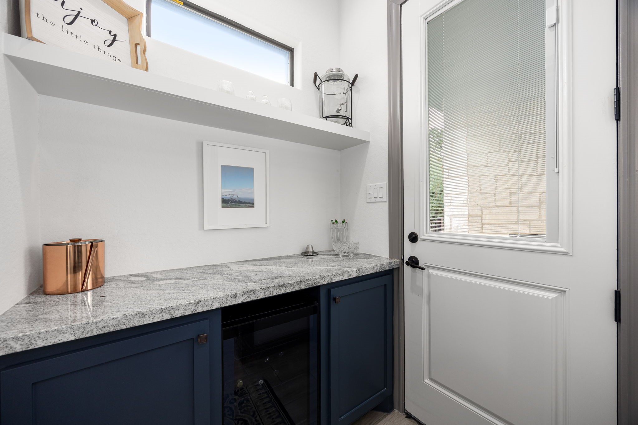 86 Dawns Edge Conroe, TX 77356 - Photo 16 of 50 MUD room with built in wine fridge. The door leads to the outdoor patio sitting area