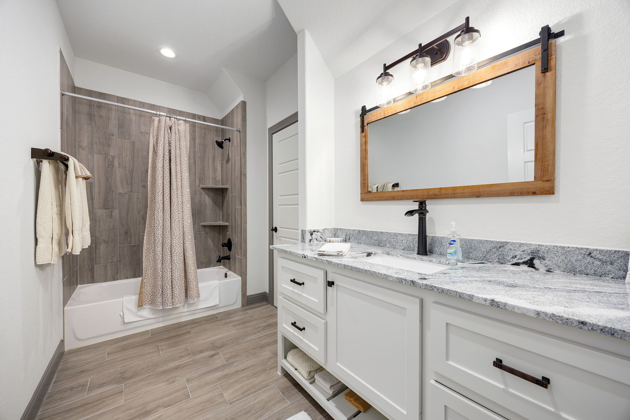 86 Dawns Edge Conroe, TX 77356 - Photo 30 of 50 a en suite bathroom with a granite countertop sink mirror and shower