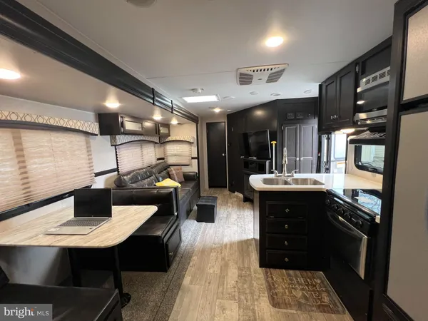 a kitchen with a sink a counter space and stainless steel appliances