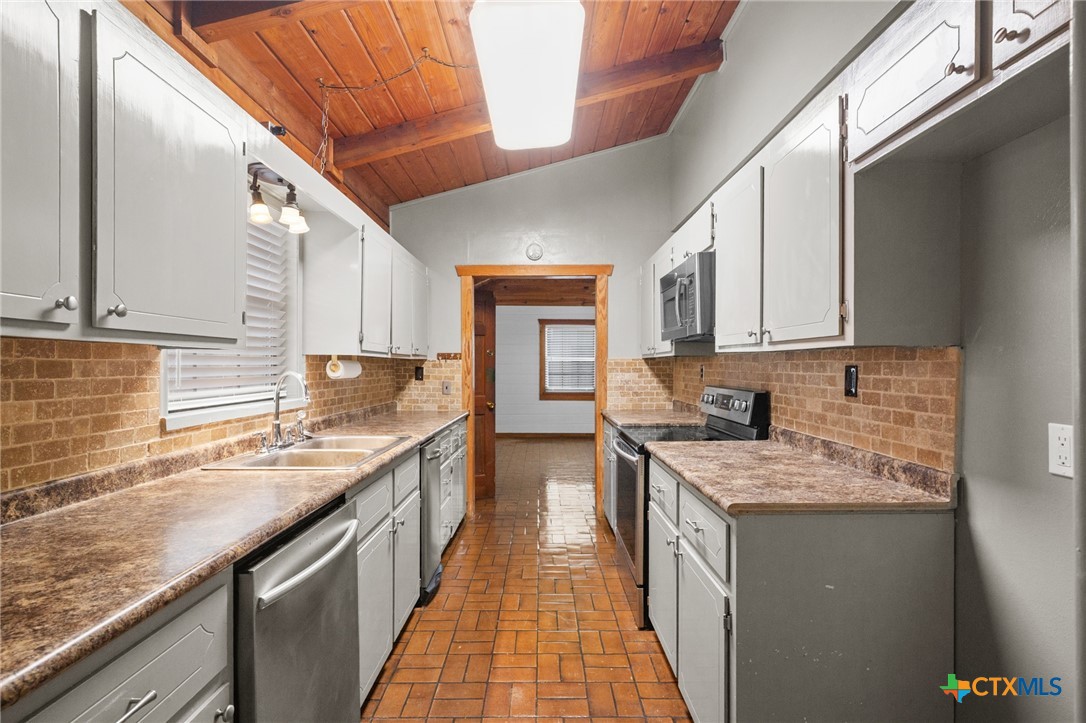 1967 Fleming Prairie Road Victoria, TX 77905 - Photo 11 of 33 a kitchen with stainless steel appliances granite countertop lots of counter top space and cabinets