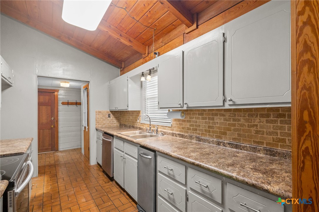 1967 Fleming Prairie Road Victoria, TX 77905 - Photo 12 of 33 a kitchen with stainless steel appliances granite countertop a sink stove and cabinets