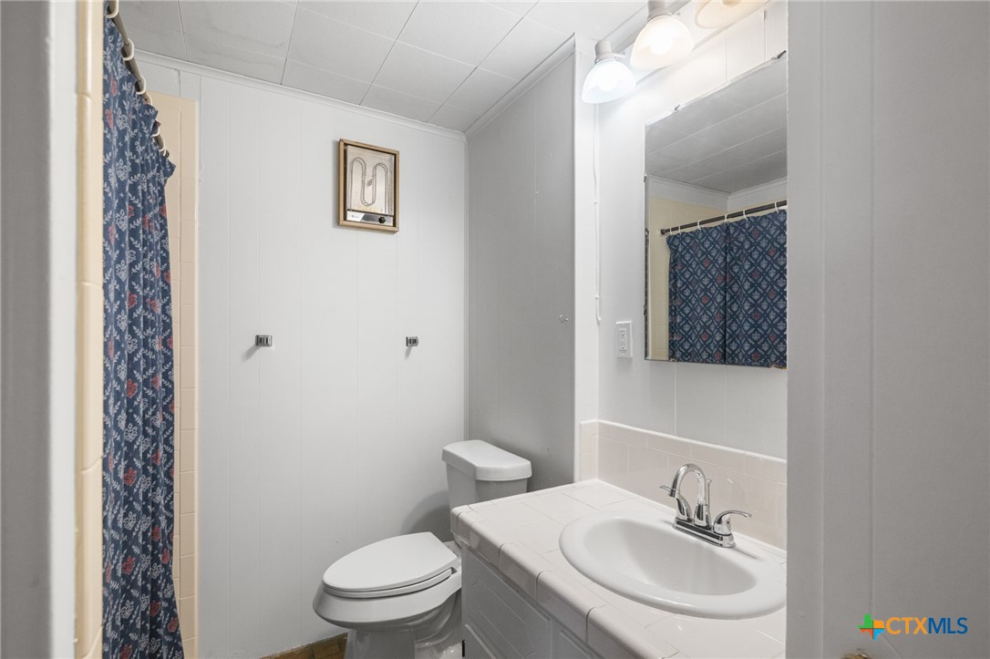 1967 Fleming Prairie Road Victoria, TX 77905 - Photo 17 of 33 a bathroom with a sink toilet and a mirror
