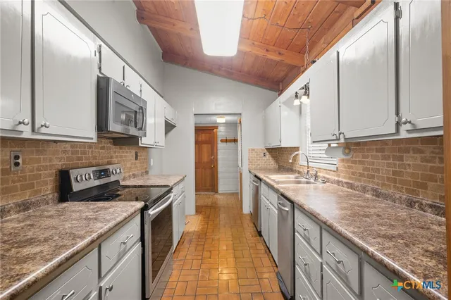 a kitchen with a sink and cabinets