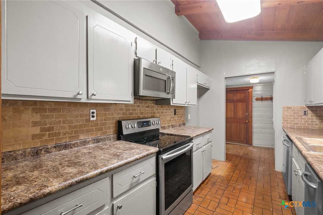 1967 Fleming Prairie Road Victoria, TX 77905 - Photo 10 of 33 a kitchen with granite countertop a sink and cabinets