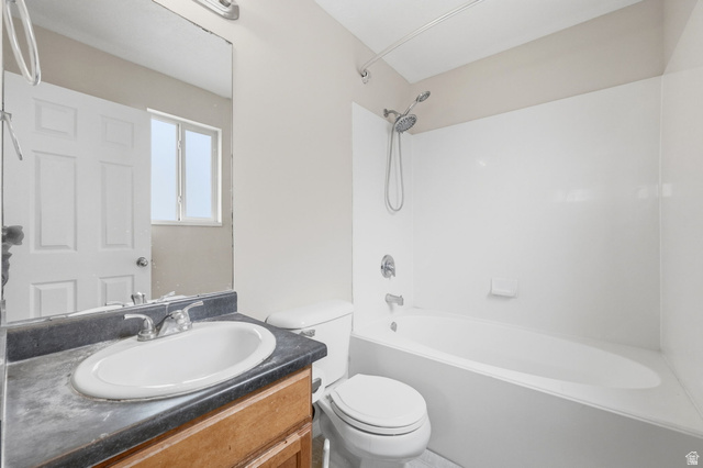 2575 Athena Drive Magna, UT 84044 - Photo 18 of 23 Bathroom featuring a single vanity with wood-finish cabinetry, a built-in sink, and a dark countertop