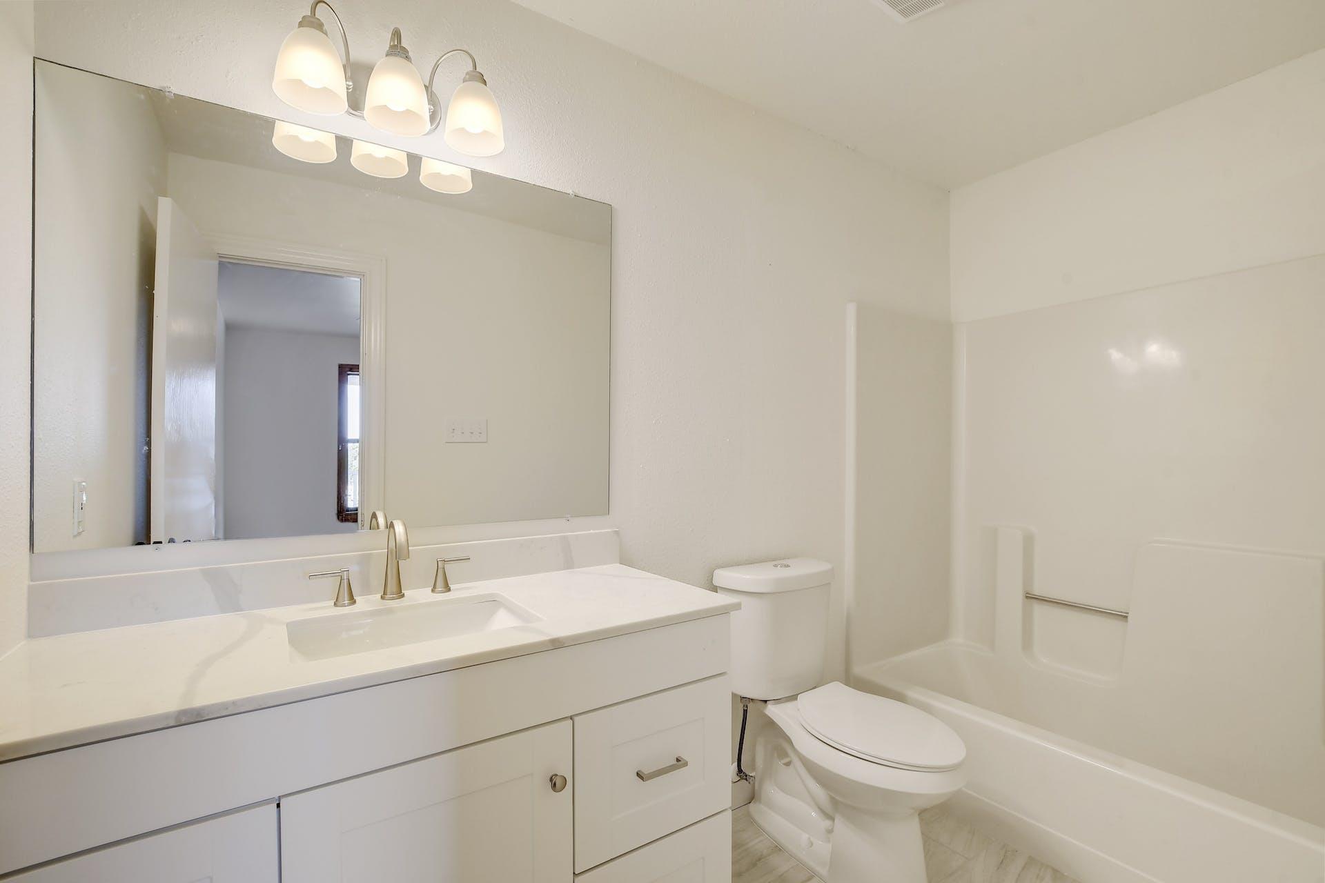 501 Myers Creek Road Dripping Springs, TX 78620 - Photo 19 of 33 A modern vanity with a large mirror defines this crisp, clean bathroom design.