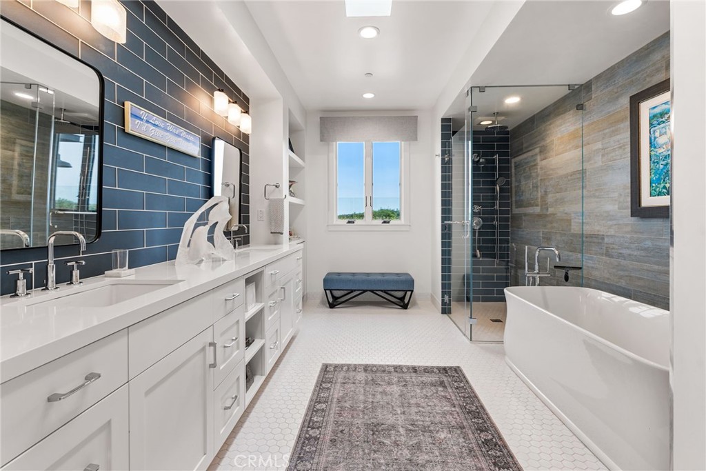 1231 Sand Key Corona del Mar, CA 92625 - Photo 12 of 65 a bathroom with a double vanity sink a mirror and a bathtub