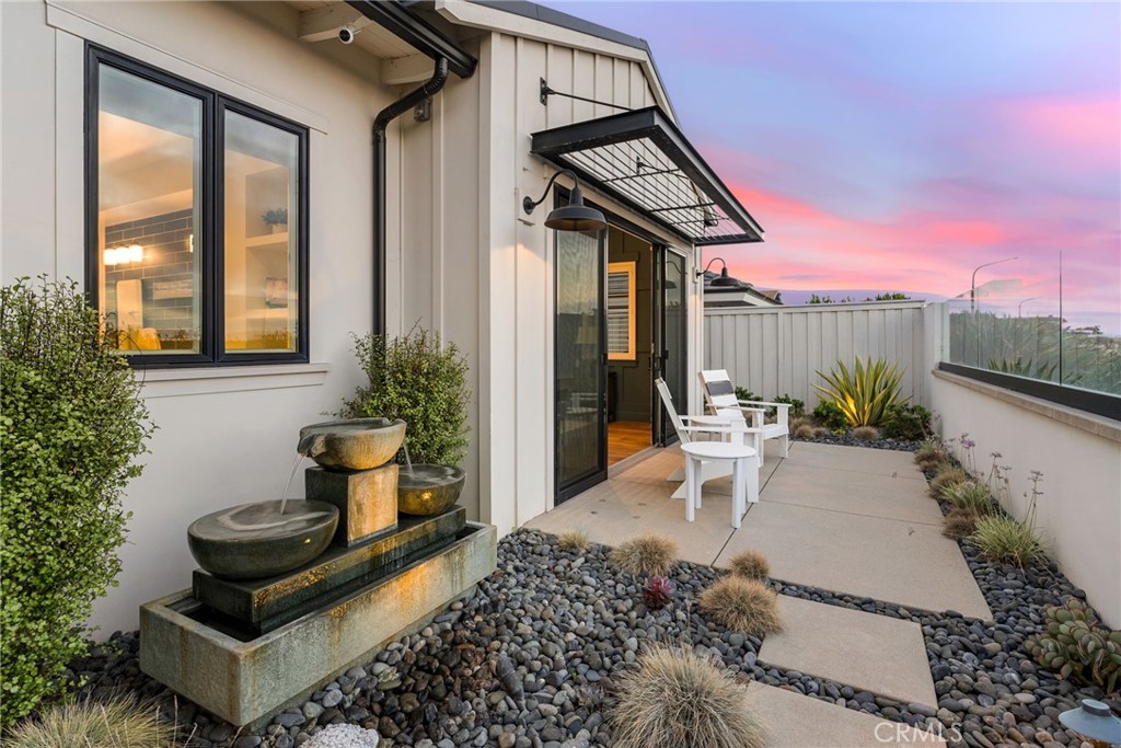 1231 Sand Key Corona del Mar, CA 92625 - Photo 14 of 65 a view of a patio with table and chairs and potted plants