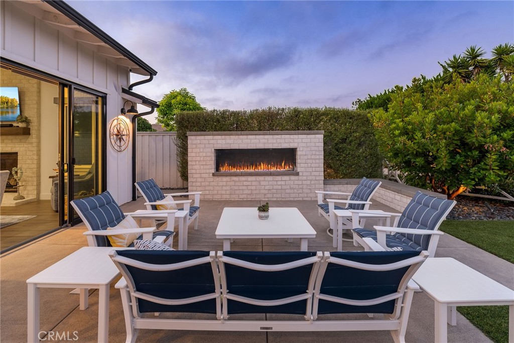1231 Sand Key Corona del Mar, CA 92625 - Photo 18 of 65 a view of a patio with table and chairs with wooden floor and fence