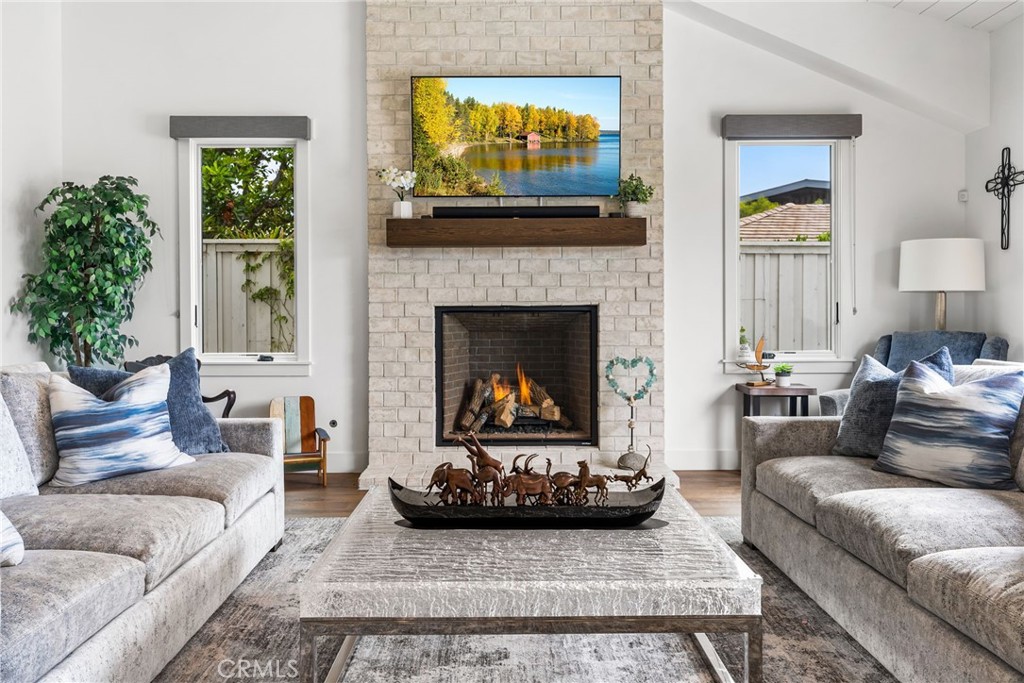 1231 Sand Key Corona del Mar, CA 92625 - Photo 25 of 65 a living room with furniture a window and a fireplace