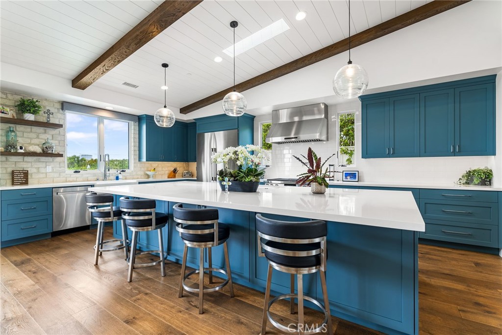 1231 Sand Key Corona del Mar, CA 92625 - Photo 31 of 65 a kitchen with a table chairs sink and cabinets