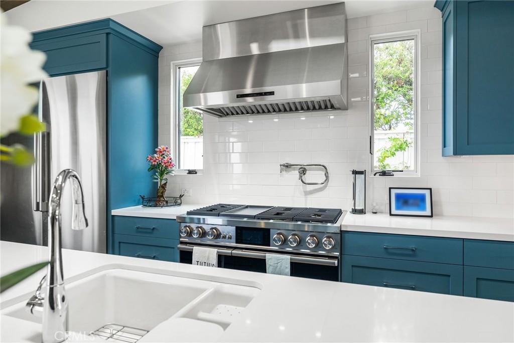 1231 Sand Key Corona del Mar, CA 92625 - Photo 32 of 65 a kitchen with stainless steel appliances granite countertop a stove a sink and a refrigerator