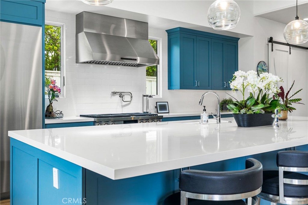 1231 Sand Key Corona del Mar, CA 92625 - Photo 33 of 65 a kitchen with a potted plant on the counter and cabinets