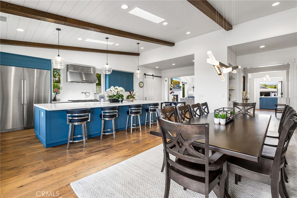 1231 Sand Key Corona del Mar, CA 92625 - Photo 35 of 65 a dining room with a wooden table and chairs