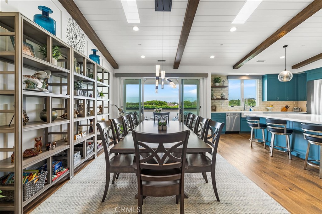 1231 Sand Key Corona del Mar, CA 92625 - Photo 37 of 65 a view of a dining room with furniture and a book shelf