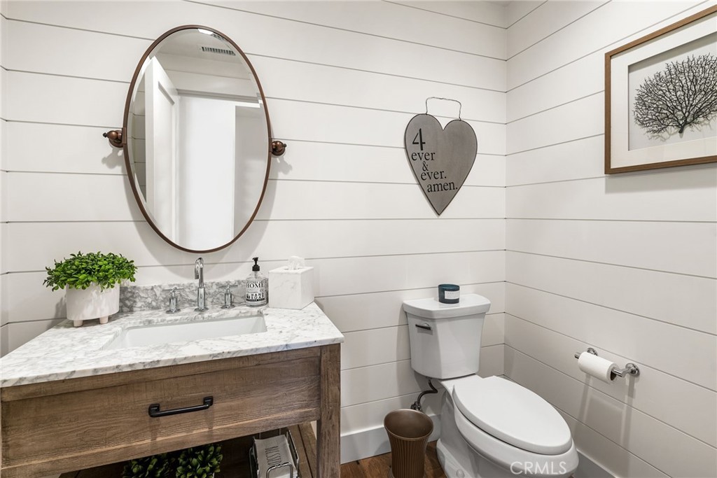 1231 Sand Key Corona del Mar, CA 92625 - Photo 40 of 65 a bathroom with a granite countertop toilet sink and mirror