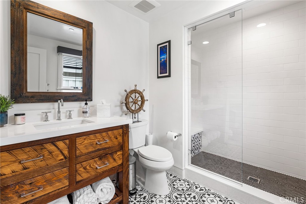 1231 Sand Key Corona del Mar, CA 92625 - Photo 50 of 65 a bathroom with a sink a toilet and mirror