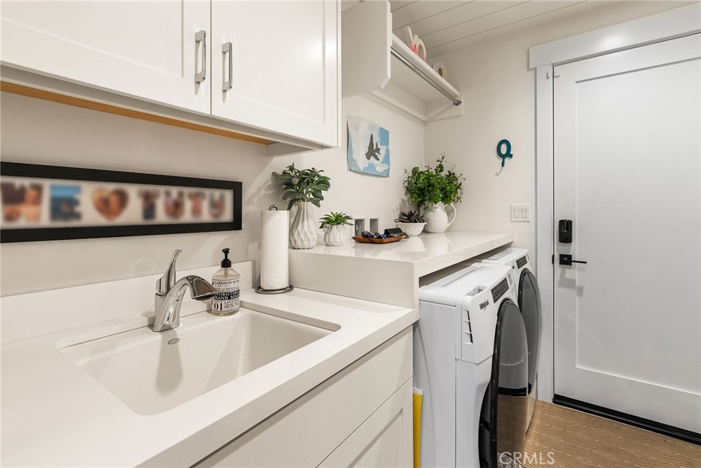 1231 Sand Key Corona del Mar, CA 92625 - Photo 53 of 65 a kitchen with a sink and a refrigerator