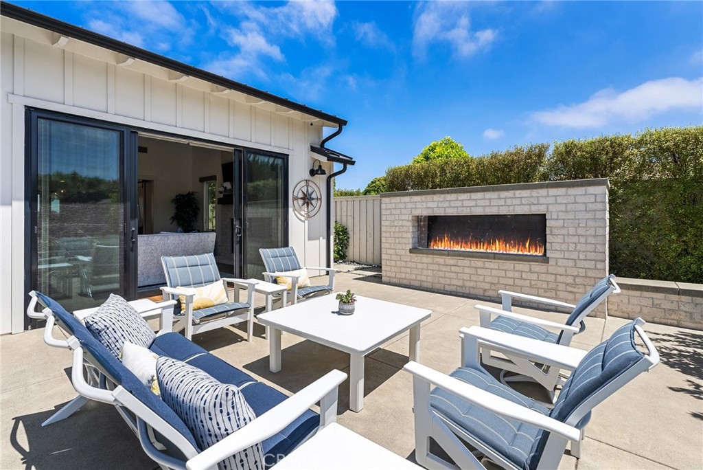 1231 Sand Key Corona del Mar, CA 92625 - Photo 56 of 65 a outdoor space with patio furniture and a fireplace