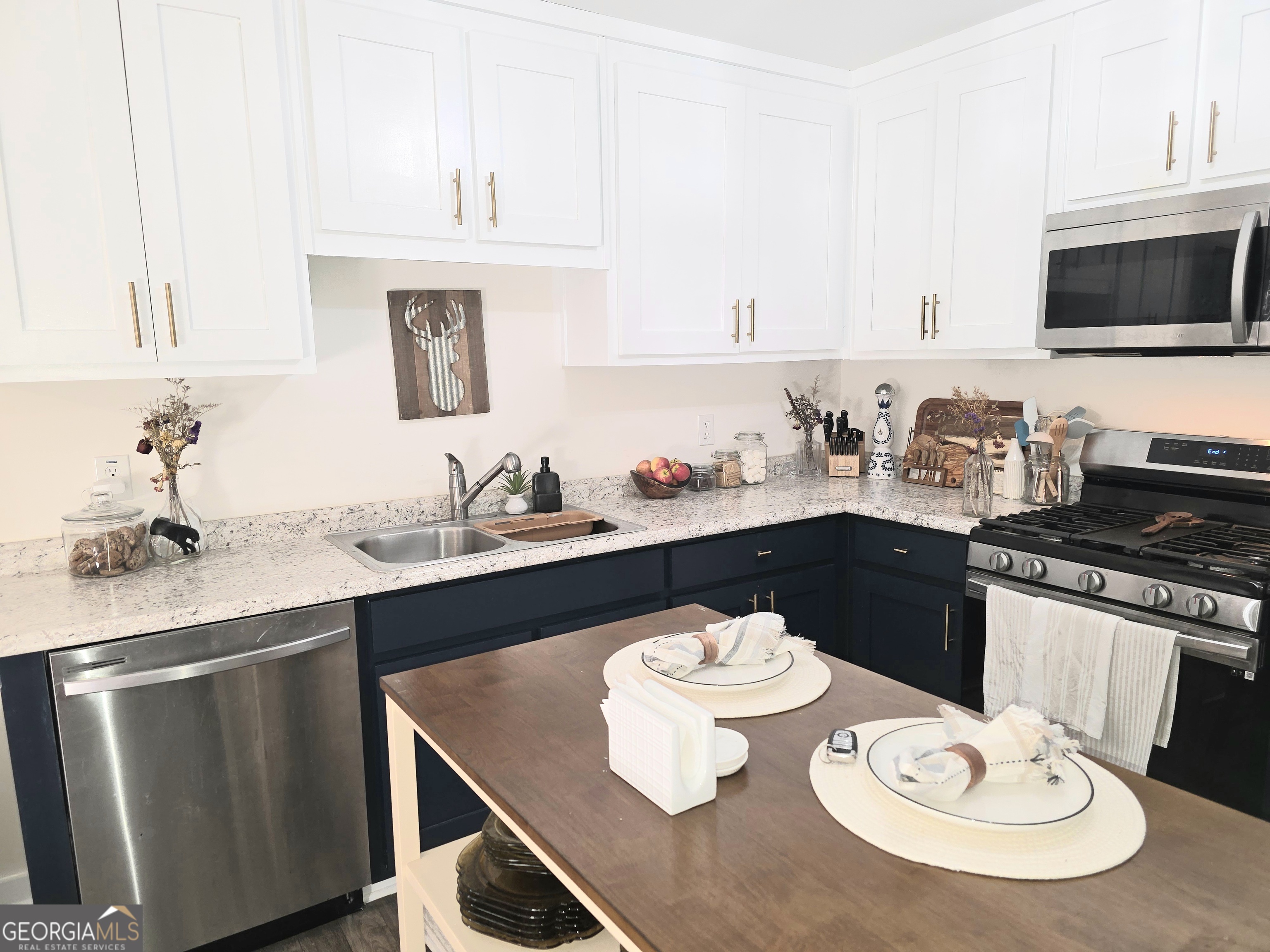 3060 Eatonton Road Madison, GA 30650 - Photo 53 of 65 a kitchen with a sink stove and dining table