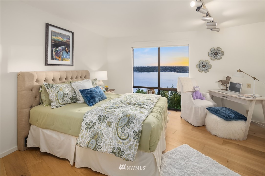 7701 Ridgecrest Lane Mercer Island, WA 98040 - Photo 23 of 35 a bedroom with a bed and a large window