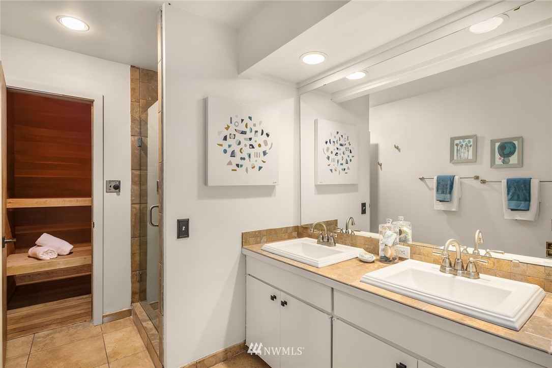 7701 Ridgecrest Lane Mercer Island, WA 98040 - Photo 25 of 35 a bathroom with a double vanity sink and a mirror