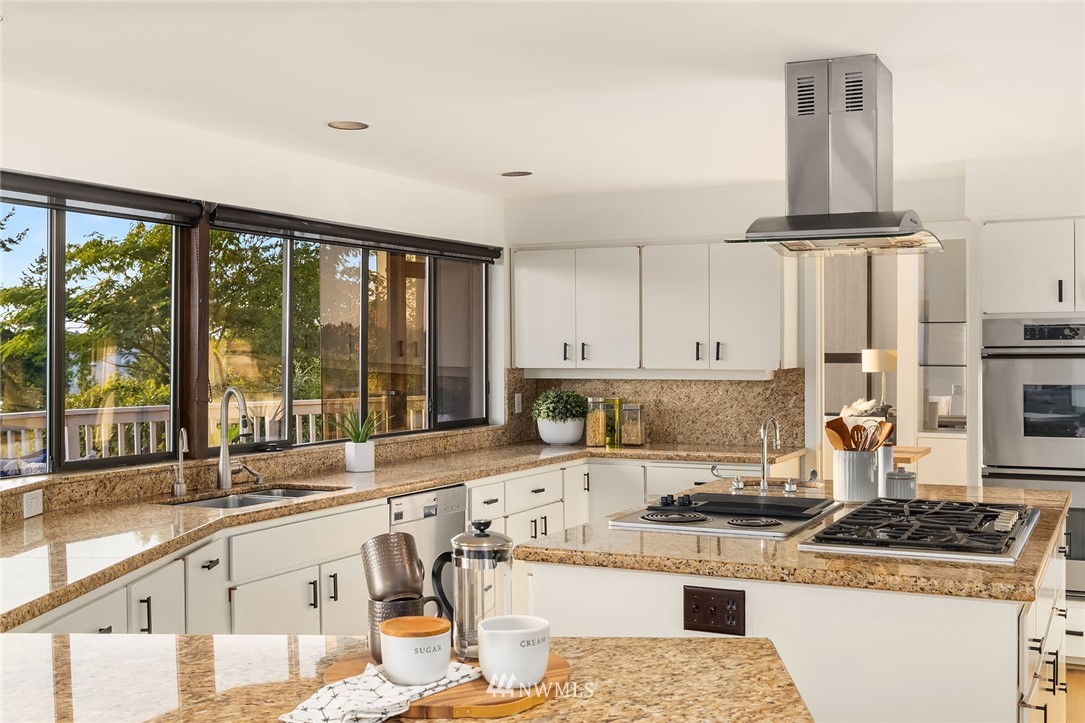 7701 Ridgecrest Lane Mercer Island, WA 98040 - Photo 10 of 35 a kitchen with stainless steel appliances granite countertop a stove a sink and a white cabinets