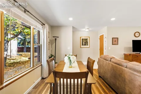 a view of a dining room with furniture large windows and wooden floor
