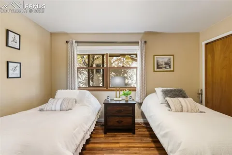 a bed sitting in a bedroom next to a window