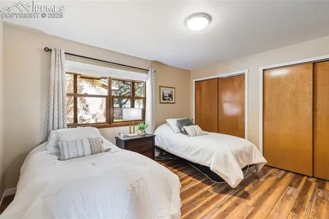 a bedroom with two beds and a window