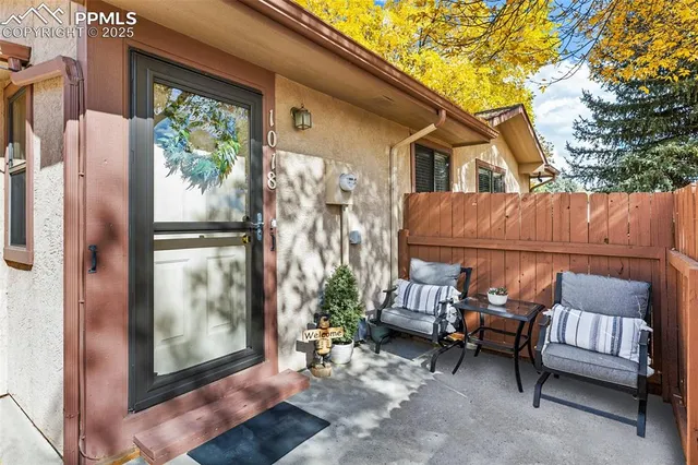a backyard of a house with outdoor seating
