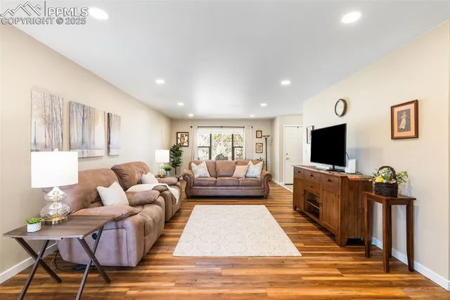 a living room with furniture and a flat screen tv