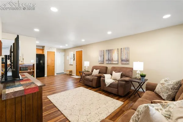 a living room with furniture and a wooden floor